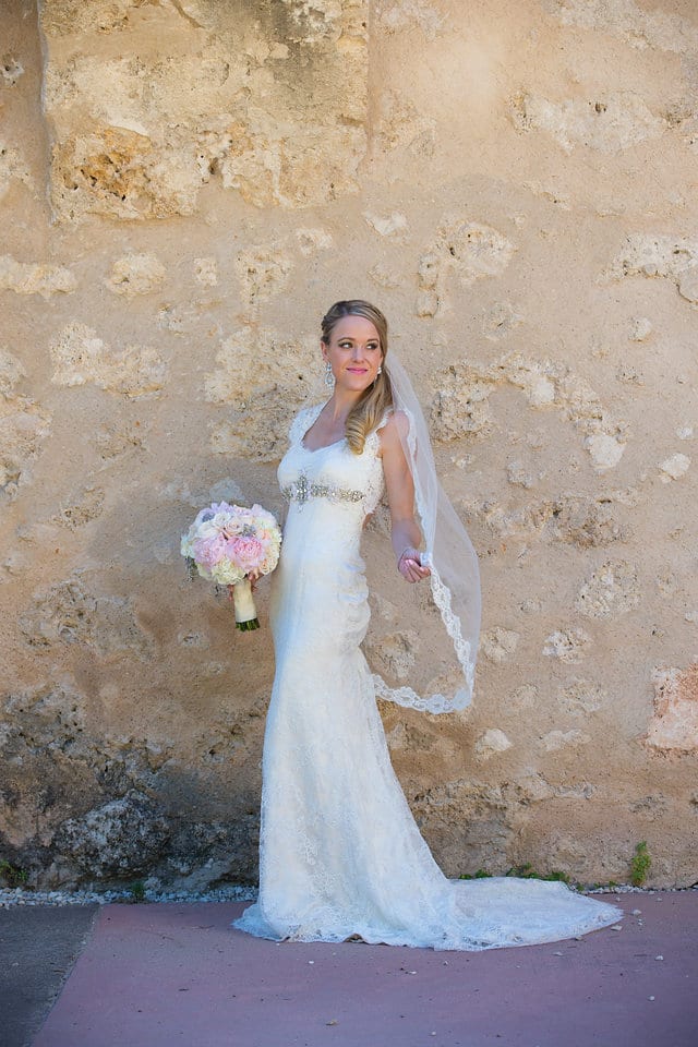 Kimb bridal at Mission Conception portrait on white wall