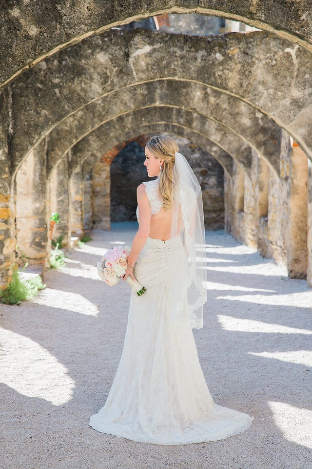 Kimb bridal at Mission San Jose portrait in the arches back of gown
