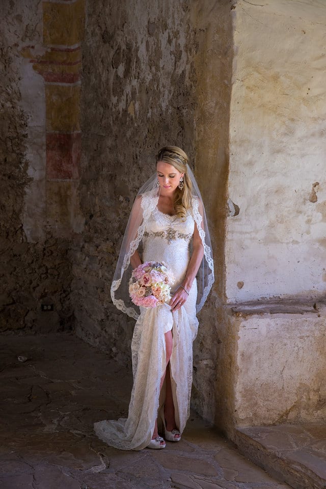 Kimb bridal at Mission San Jose Rose granary holding the dress up