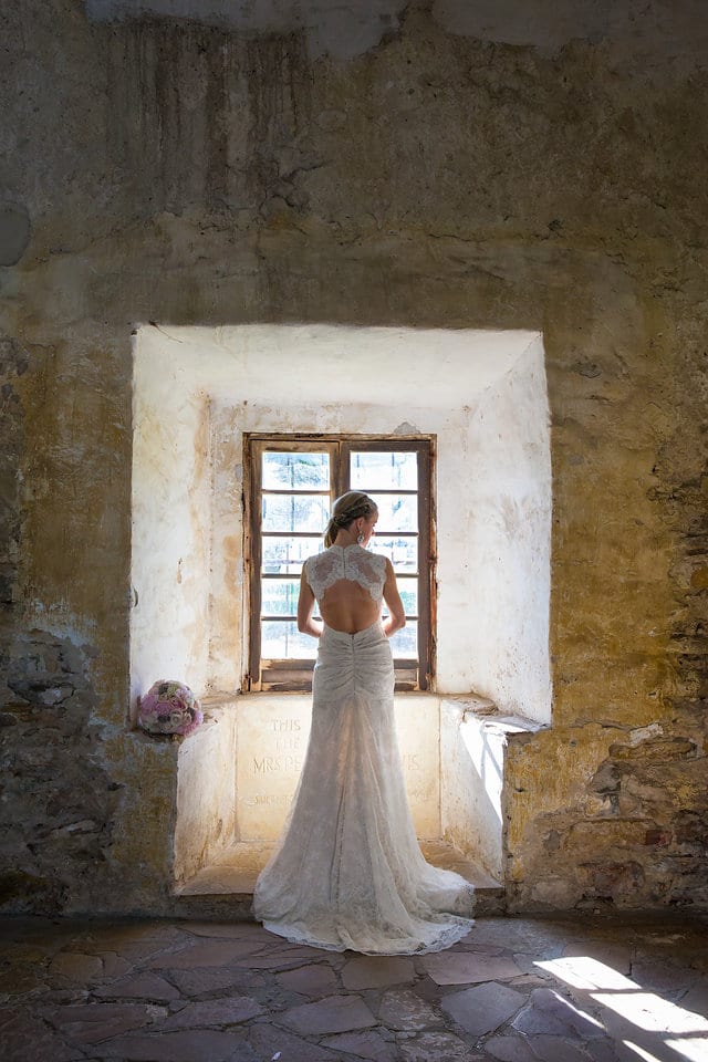 Kimb bridal at Mission San Jose Rose granary window back of dress