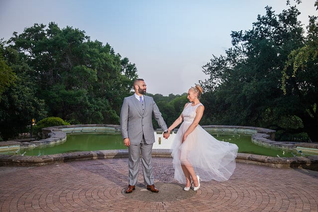 Nick and Liz wedding couple portraits at the McNay Art Museum by fountain dancing