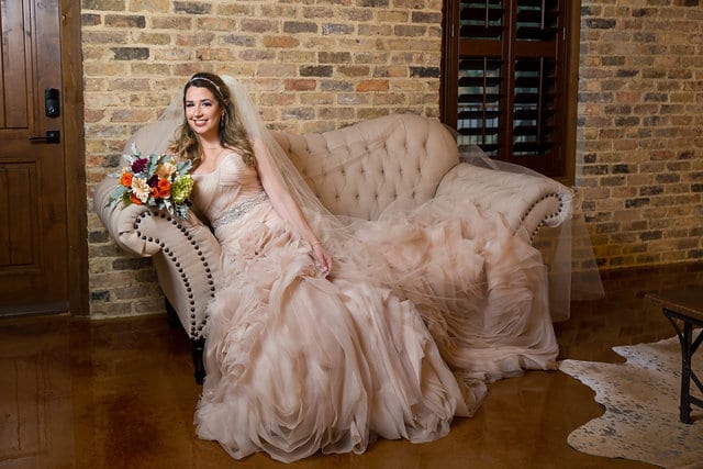 Victoria's bridal at The Chandelier of Gruene bridal suite on the sofa