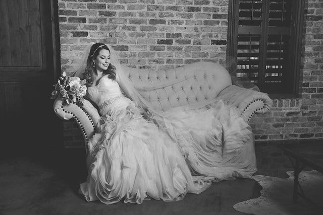 Victoria's bridal at The Chandelier of Gruene bridal suite on the sofa black and white
