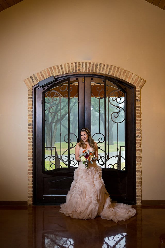 Victoria's bridal at The Chandelier of Gruene bride at the doors looking in with flowers