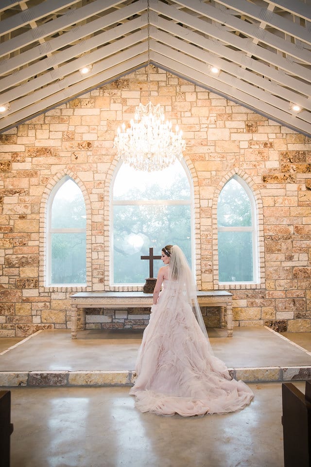 Victoria's bridal at The Chandelier of Gruene bride in the aisle back of dress