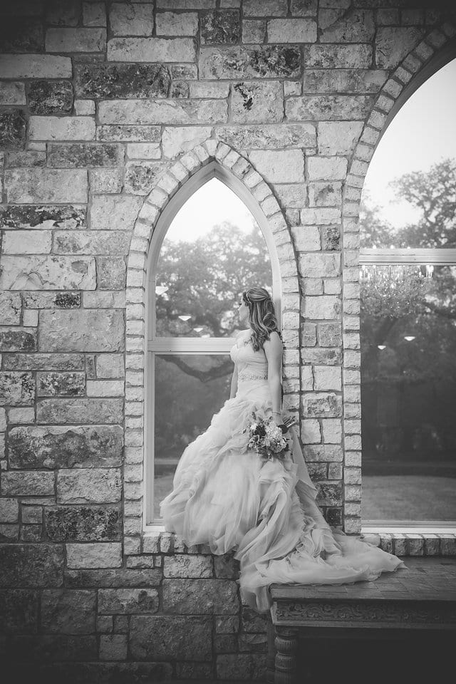 Victoria's bridal at The Chandelier of Gruene in standing in the window black and white