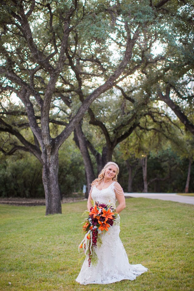 Whitney's Bridal portrait the Chandelier of Gruene in the trees laughing