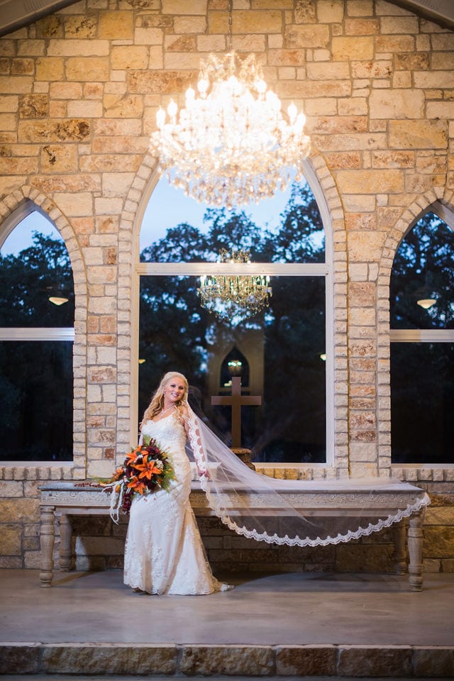 Whitney's Bridal portrait the Chandelier of Gruene in the chapel sitting on the table