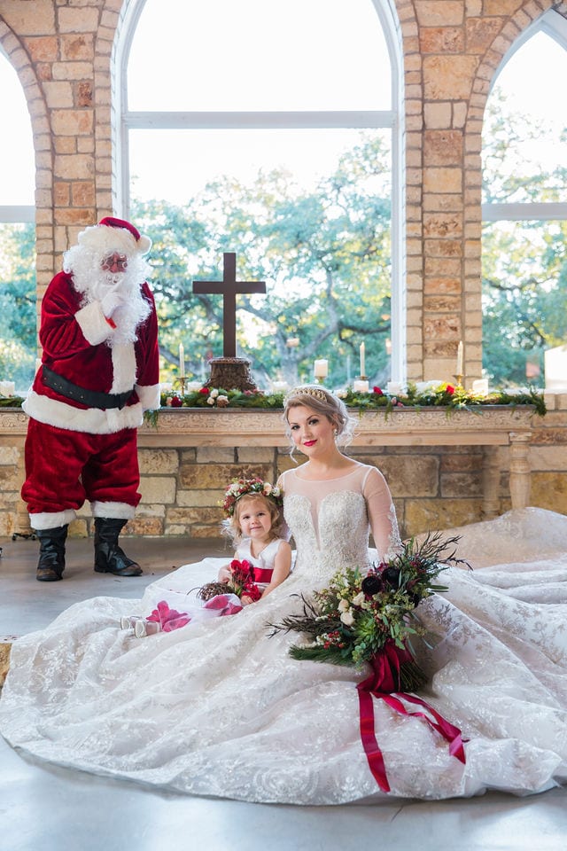 Styled shoot Chandelier of Gruene Christmas Bride and flower girl waiting for Santa