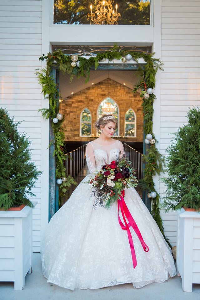 Styled shoot Chandelier of Gruene Christmas Bride in the doorway