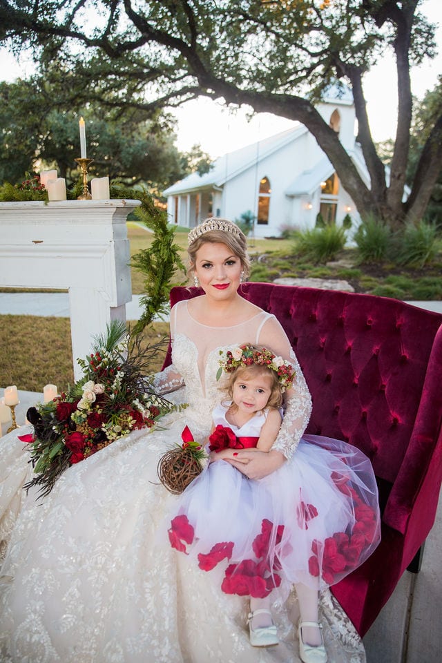 Styled shoot Chandelier of Gruene Christmas Bride and flower girl on the sofa close up