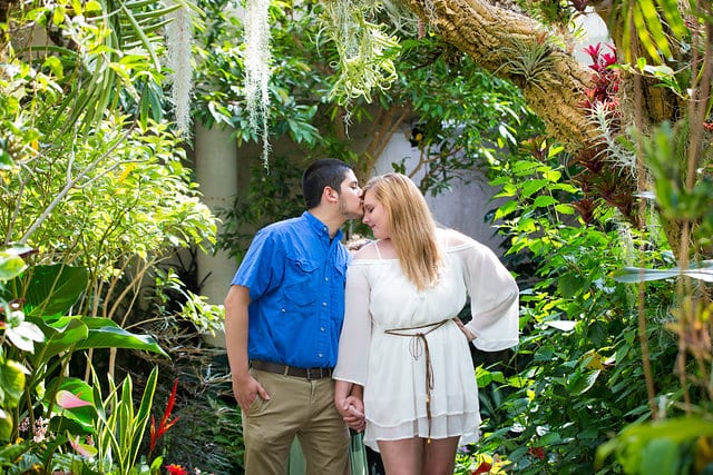 Cantu engagement head kiss on the bridge San Antonio Botanical Garden tropical atrium