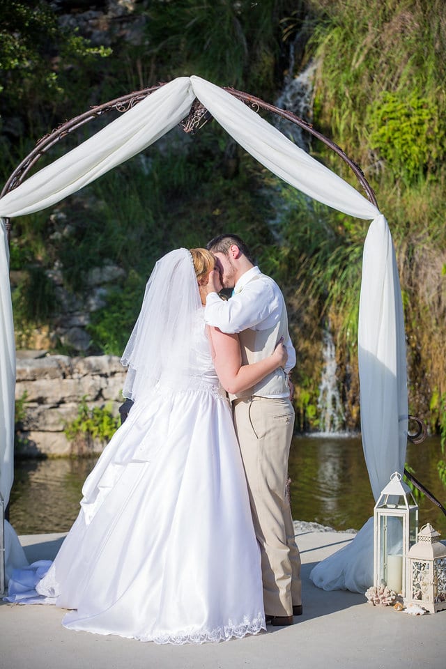 Cassie and John wedding Hidden Falls ceremony kiss