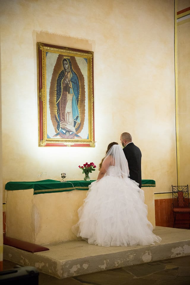 Felicia and Rick's Wedding, bride and groom praying to the virgin Mary