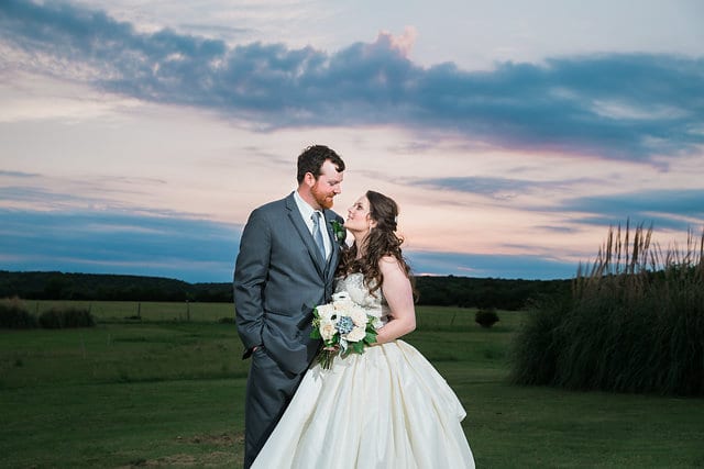 Heather and Wesley's Wedding, bride and groom holding each other with hill country background