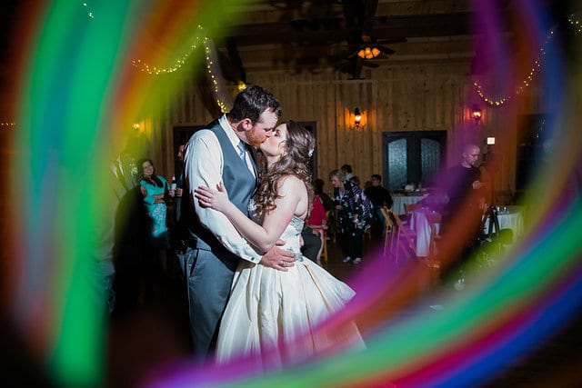 Heather and Wesley's Wedding, bride and groom with glow sticks kissing