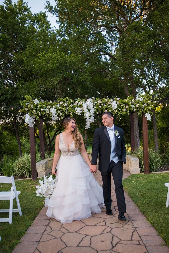 Styled wedding shoot at Olympia Hills San Antonio bride and groom on the aisle laughing