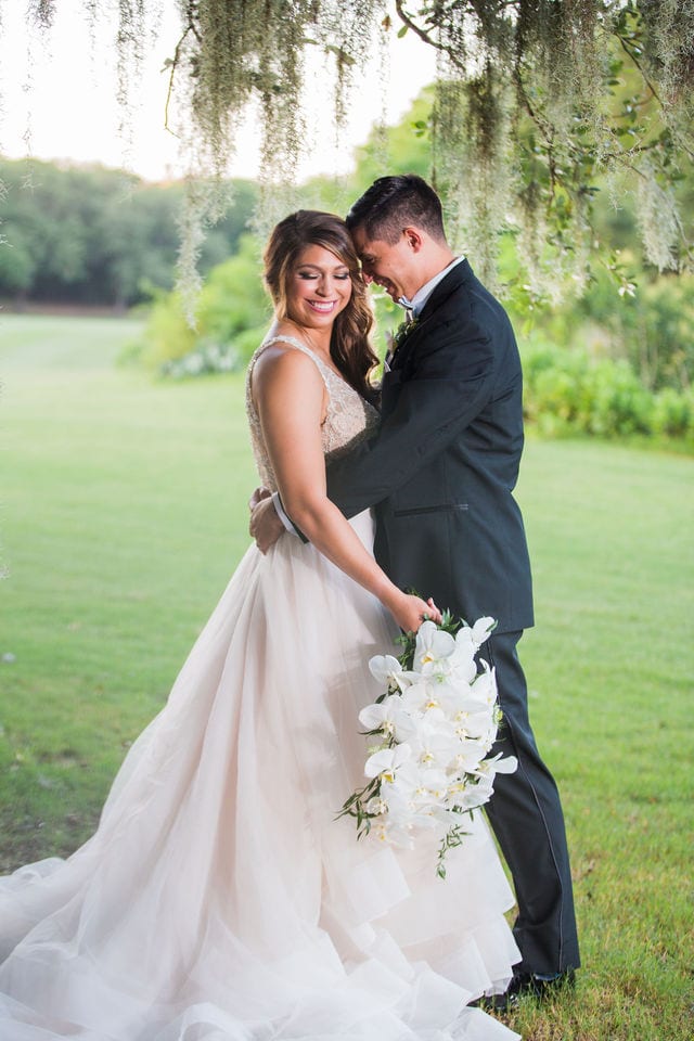 Styled wedding shoot at Olympia Hills San Antonio bride and groom in the moss smiling