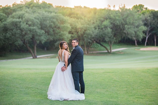 Styled wedding shoot at Olympia Hills San Antonio bride and groom on the green in the sun