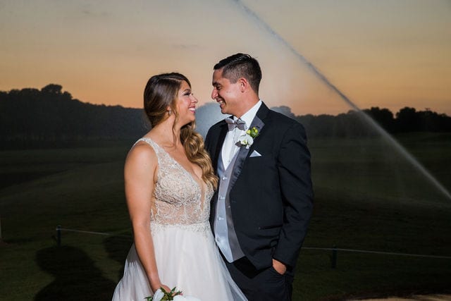 Styled wedding shoot at Olympia Hills San Antonio bride and groom sprinkler by the pond