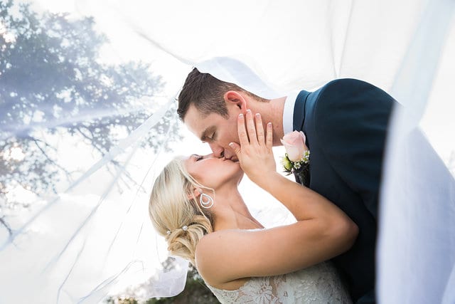 Anna and Trae New Braunfels Wedding Bride and Groom kissing under veil