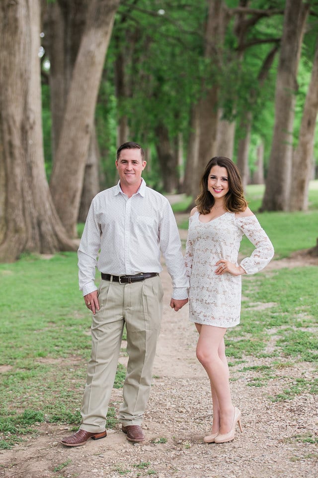 Grisham engagement portrait of the couple holding hands in the trees