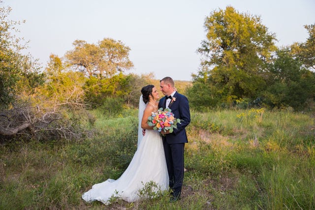 Edwards Wedding couple in the field at Milestone, New Braunfels