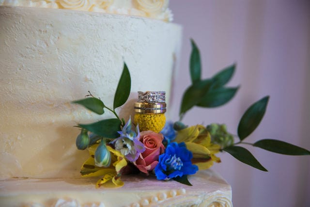 Katie C wedding the MIlestone reception rings on cake