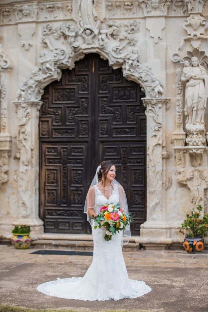 Gaby Bridal at Mission San Jose mission doors portrait with flowers
