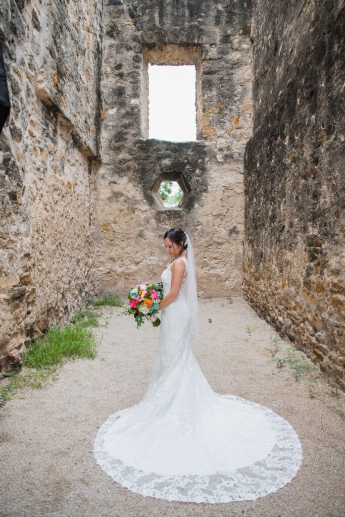 Gaby Bridal at Mission San Jose portrait with the bouquet in walkway