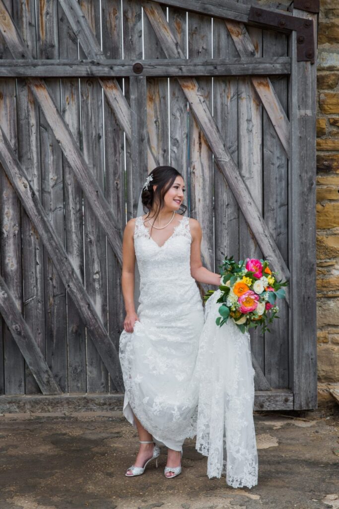 Gaby Bridal at Mission San Jose portrait with the wooden gate shoes