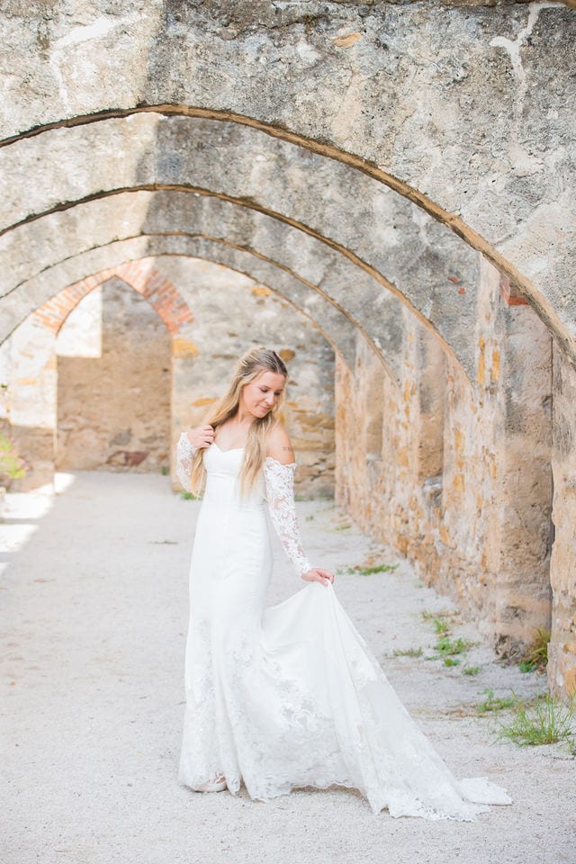 Kelsey's bridal at Mission San Jose walking out of arches