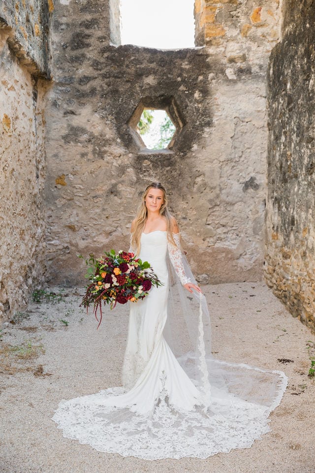 Kelsey's bridal at Mission San Jose hall portrait with flowers