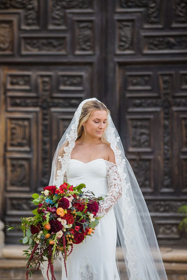 Kelsey's bridal at Mission San Jose at large doors, portrait bouquet