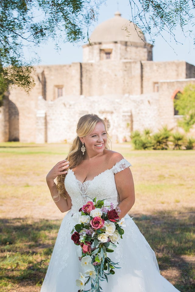 KR Bridal session at Mission San Jose in front of the mission laughing