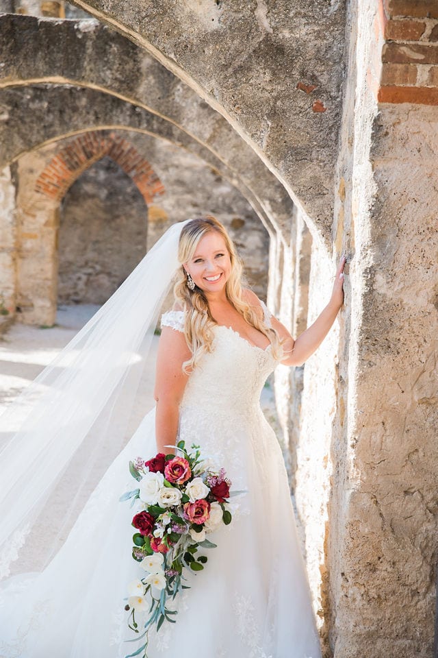KR Bridal session at Mission San Jose bride in the arches with the bouquet