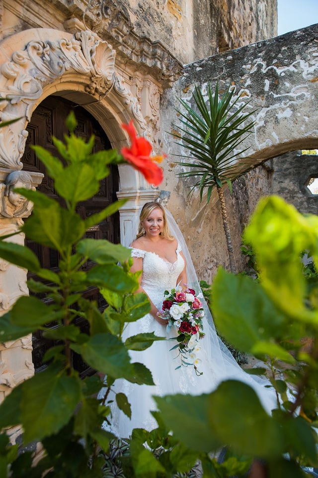KR Bridal session at Mission San Jose bride rose window door with flowers