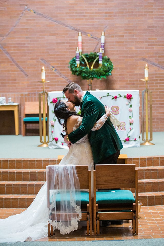 The couple's ceremony kiss San Antonio wedding at St Mark's Wedding