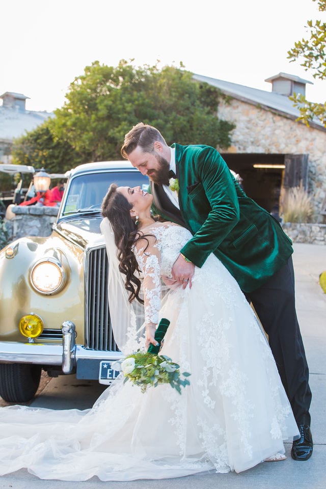 Bride and Groom kissing with the Rolls Royce Canyon Springs wedding