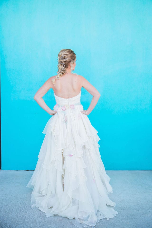 Bridal gown at I do the dress I Do with portrait flower gown blue wall back