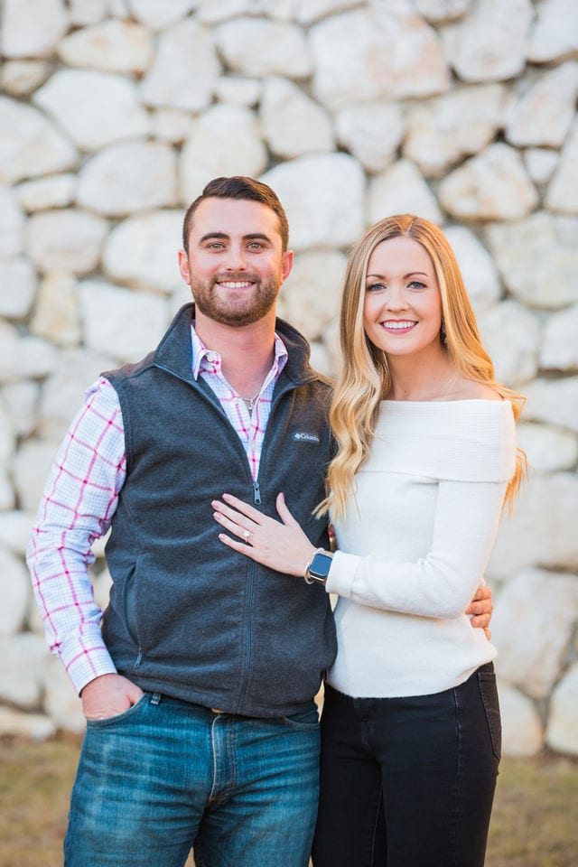 Engagement photography at JW Marriott couple by the stone wall