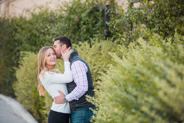 Engagement photography at JW Marriott in the greenery laughing
