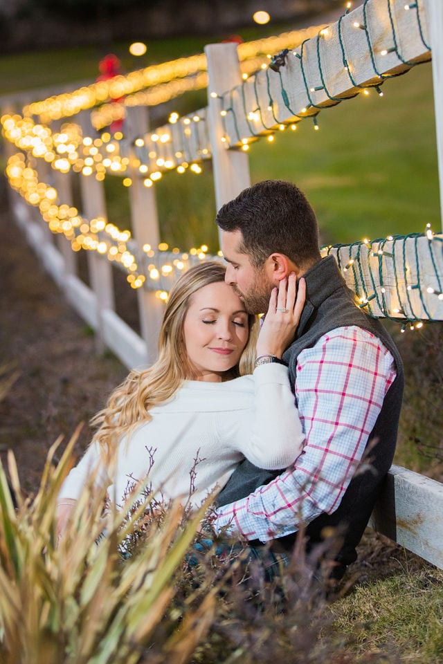 Engagement photography at JW Marriott couple sitting by Christmas lights