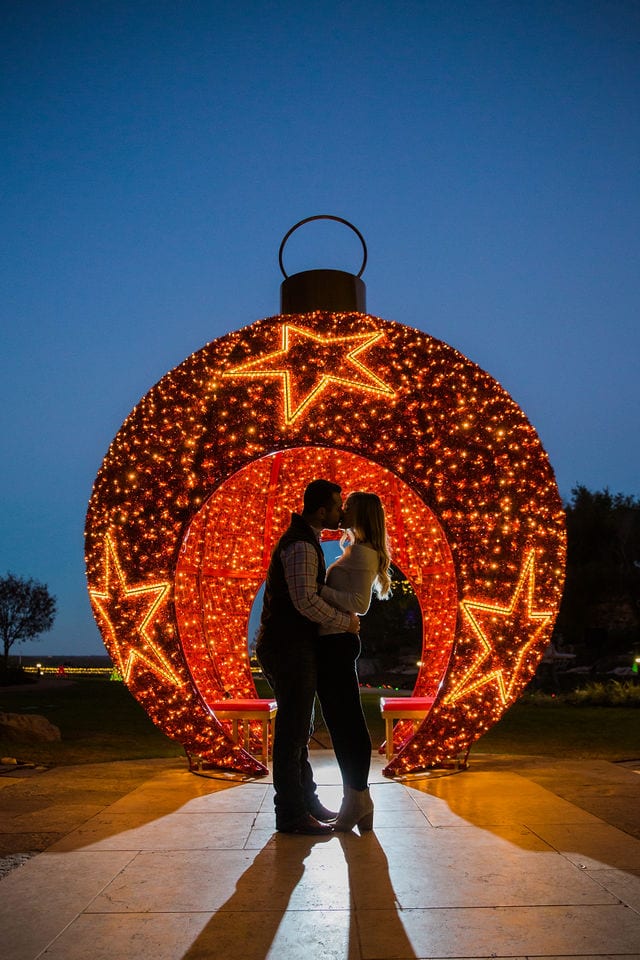 Engagement photography at JW Marriott couple portrait by big ornament at night