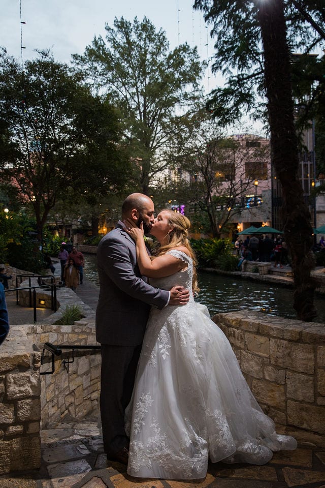 Bride and groom romantic kiss on the riverwalk, San Antonio wedding