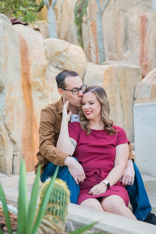Weber couple in the desert atrium at San Antonio Botanical Gardens kiss