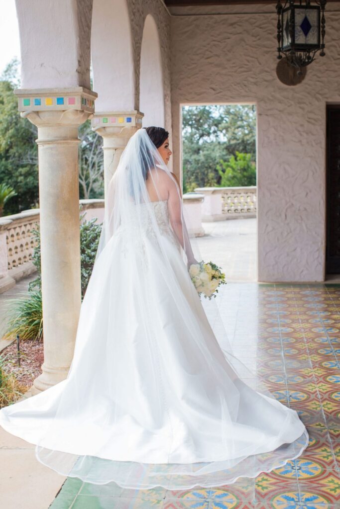 Back of gown bridal portrait on patio, Camille at McNay Art Museum
