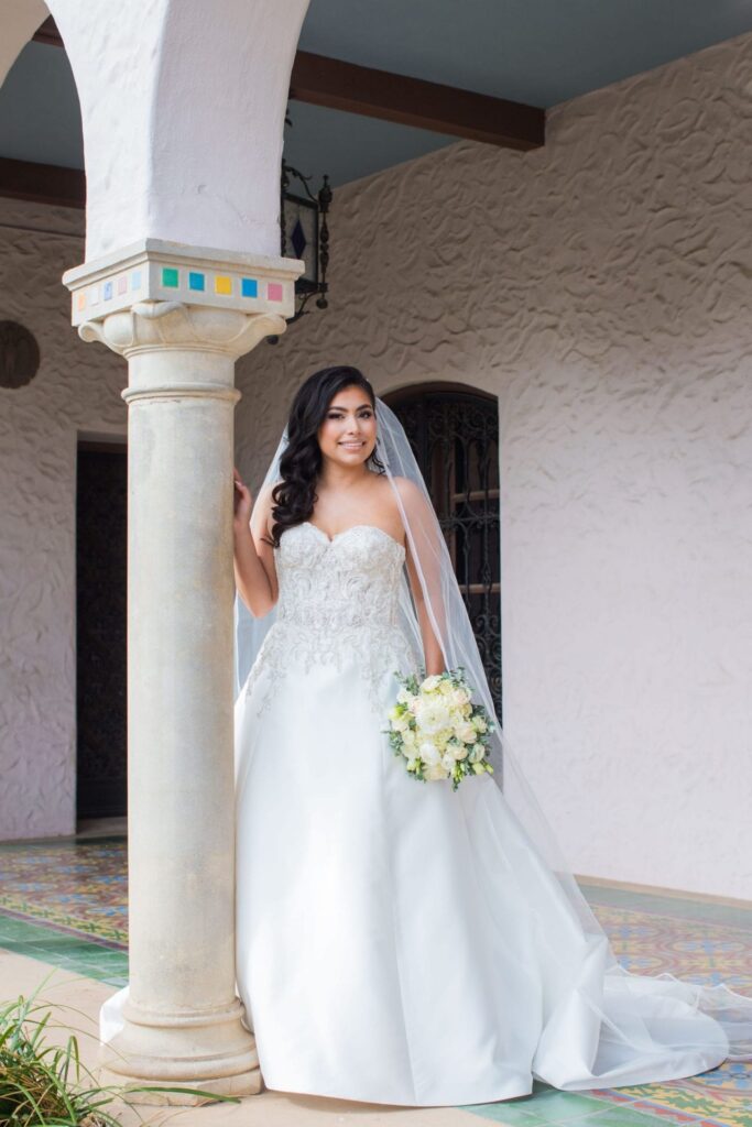Bridal portrait by column, Camille at McNay Art Museum