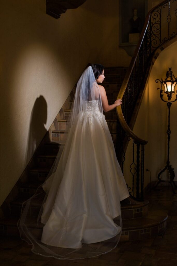 Bridal portrait on the staircase, Camille at McNay Art Museum