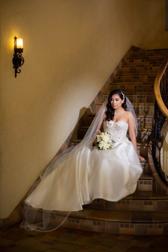 Bridal portrait sitting on staircase, Camille at McNay Art Museum